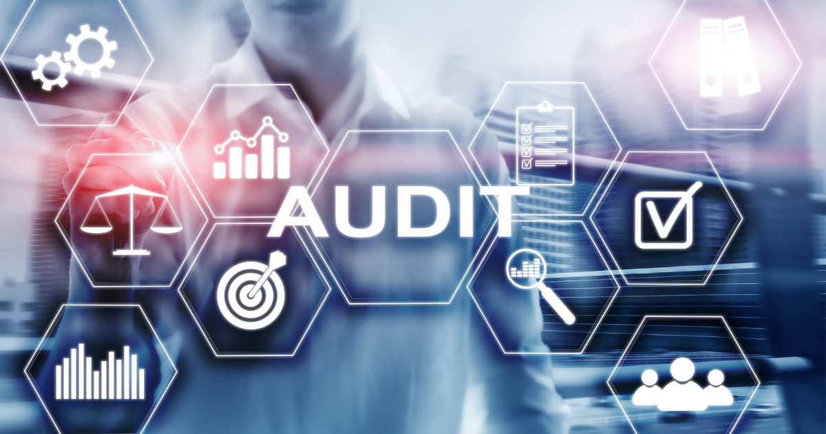 Some machinery on a blue background overlaid with the word audit.