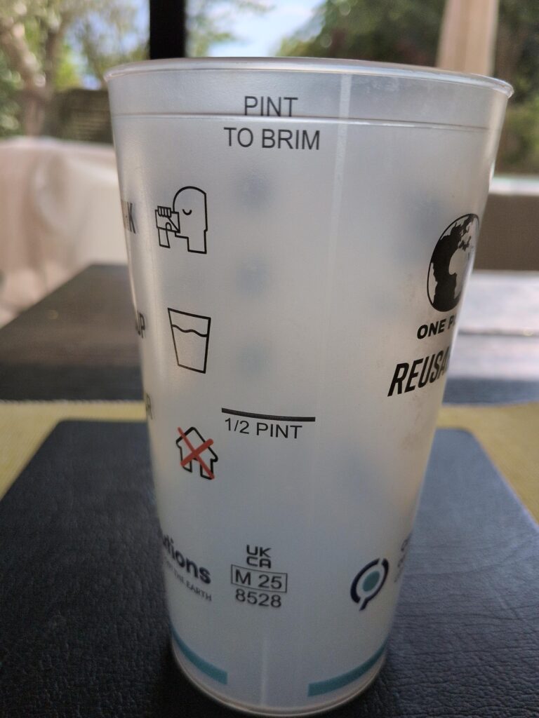 A plastic pint glass spotted at Newmarket Racecourse showing the UKMB verification label.